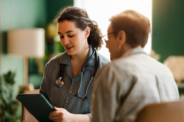 Female patient and a doctor talking in hospital.